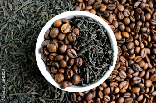 Coffee beans and tea in leaves on the same plate