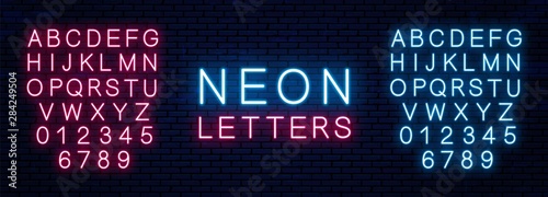 Bright neon letters of red and blue color isolated on brick wall background. Vector neon font.