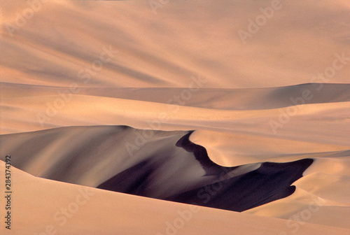 Asia, China, Dunhuang. These immense sand dunes are a popular tourist attraction at Dunhuang in Gansu Province, China.