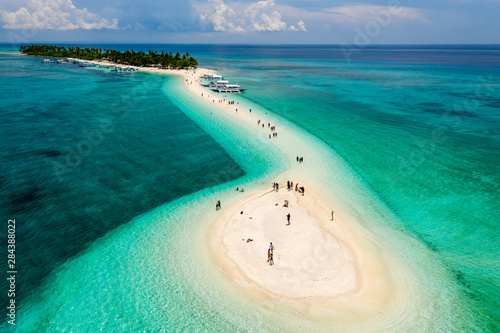 Aerial drone view of a beautiful tropical island with sandy beach surrounded by Coral Reef (Kalanggaman Island, Philippines)