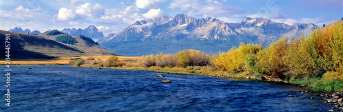 USA, Idaho, Sawtooth NRA. The Salmon River courses wide and azure before the rugged Sawtooth range in Sawtooth NRA, Idaho.