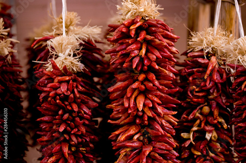 NA, USA, New Mexico, Santa Fe, Plaza, Dried Strings of Chili Peppers Hanging 