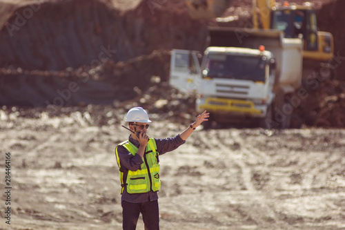 Portrait of asian male supervisor in mine soil field location operation a radio or walkie talkie