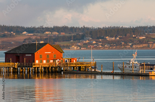 USA, WA, Whidbey Island, Coupeville. Wharf and whale watching boat at first light Penn Cove