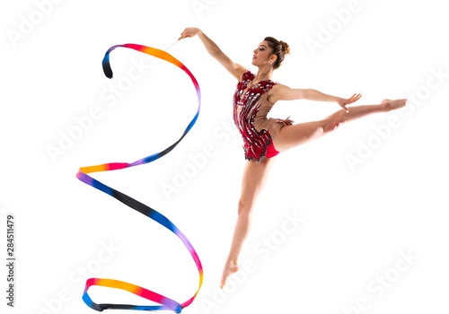 Girl doing rhythmic gymnastics with ribbon . jumping