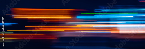 Abstract Rainbow light trails on the dark background