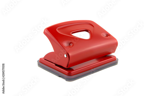 Red office paper hole puncher, isolated on white background