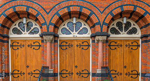 Three old wooden doors at Saint Andrews Presbyterian church in Victoria, British Columbia, Canada