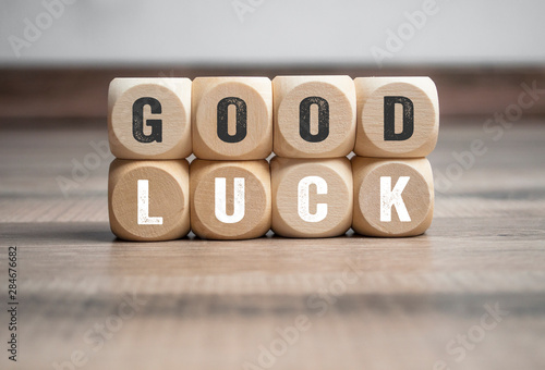 Cubes and dice with good luck on wooden background