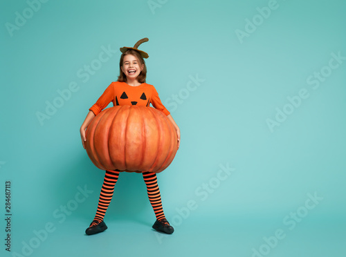 little girl in pumpkin costume