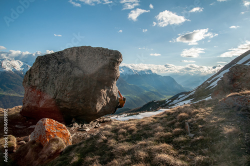 Young woman bouldering in the swiss alps