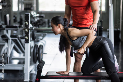 trainer coach dumbbell exercise to woman