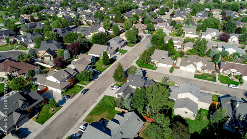 Main street leads through a subdivision with homes and trees