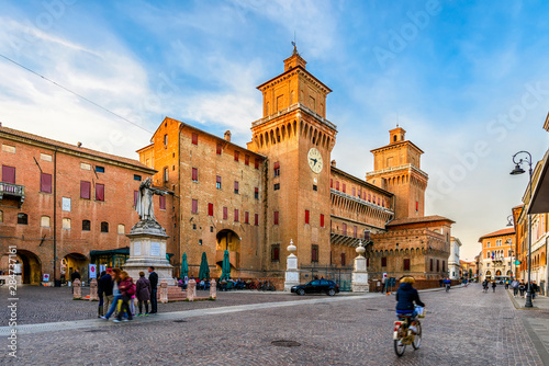 Castle Estense (Castello Estense) and piazza Savonarola and monumet to Savonarola in Ferrara, Emilia-Romagna, Italy. Ferrara is capital of the Province of Ferrara