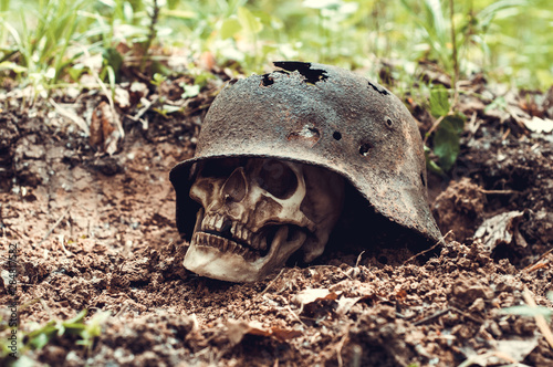 German military helmet. Third Reich.human skull.The Second World War. leaky and rusty military German helmet. archeological find.