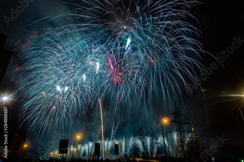 Blue festive fireworks on a black background. Abstract holiday background. International Fireworks Festival ROSTEC