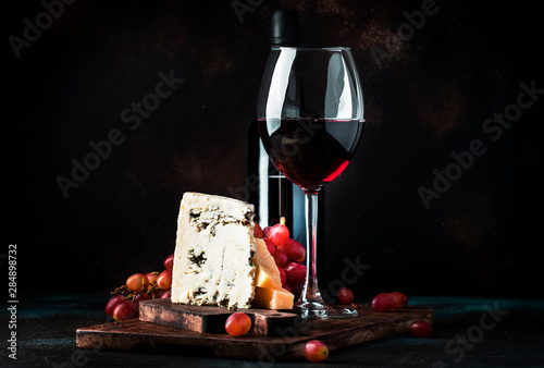 Port wine and blue cheese, still life in rustic style, vintage wooden table background, selective focus