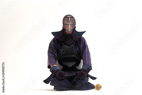 Portrait of man kendo fighter with shinai bamboo sword . Shot in studio. Isolated with clipping path on white background