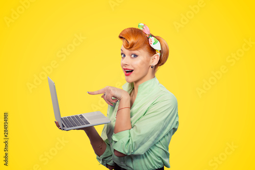 Surprised girl pointing finger to laptop
