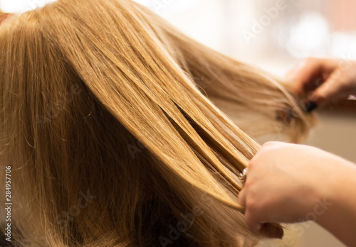 Golden blonde hair on a woman in a beauty salon