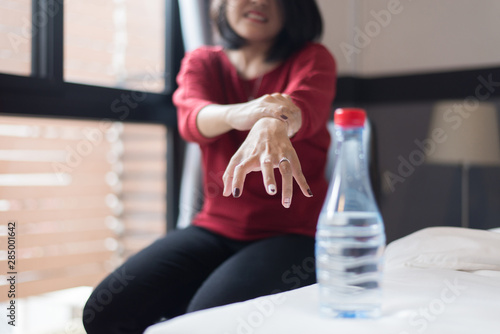 Woman suffering with parkinson disease symptoms,Selective focus