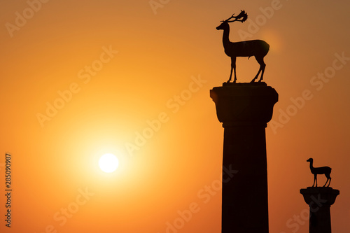 The deer statues at the entrance to Rhodes harbor at sunrise