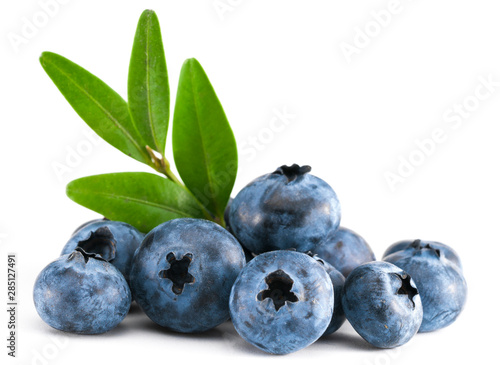 Fresh raw tasty blueberries with leaves isolated on white
