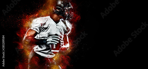 American football player. Sportsman with ball in helmet on stadium in action. Sport wallpaper. Team sports.