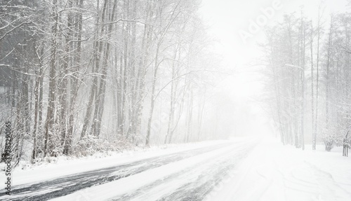 Snowy winter road during blizzard in Latvia