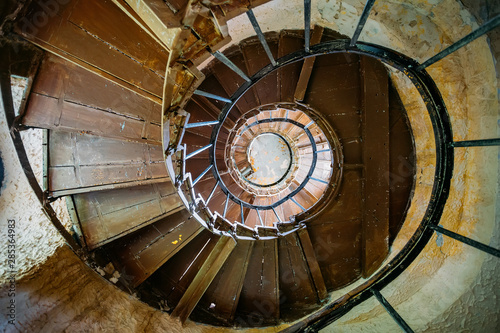 Old spiral staircase in abandoned mansion, bottom view