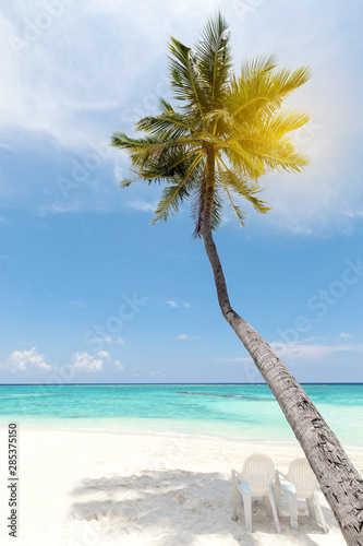 Chaise-longues in beach, travel card