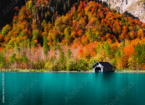 autumn landscape with lake and boathouse