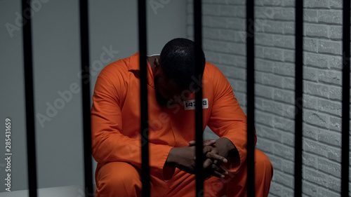 Pensive african-american prisoner waiting for visitors, serving life sentence