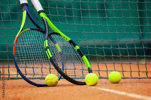 Tennis rackets and balls leaned against the net.