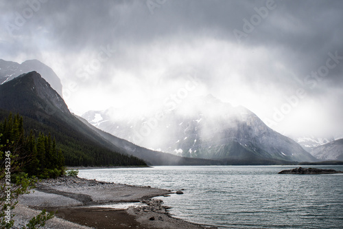Hiking under the clouds and rain at the Upper Kananaskis Lake in the Canadian Rockies in Alberta
