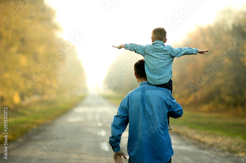 father and son walk in nature