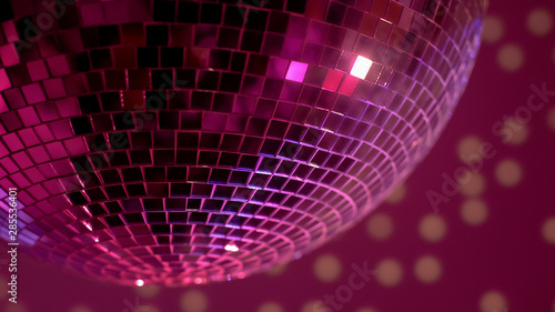 Mirror disco ball in nightclub lights, festive party atmosphere, performance