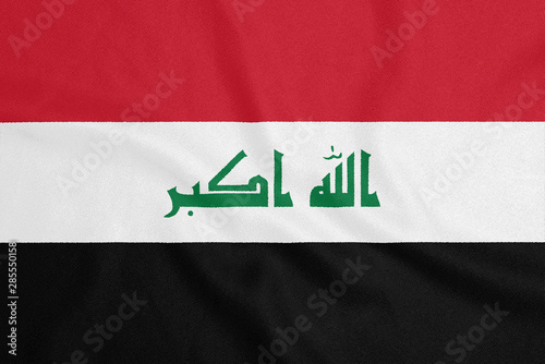 Flag of Iraq on textured fabric. Patriotic symbol