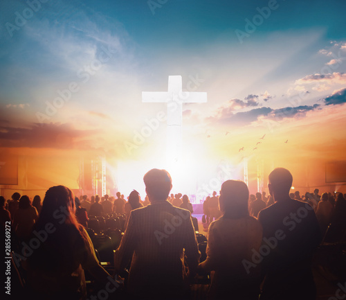 Worship concept: Group of people holding hands praying worship at sunset background