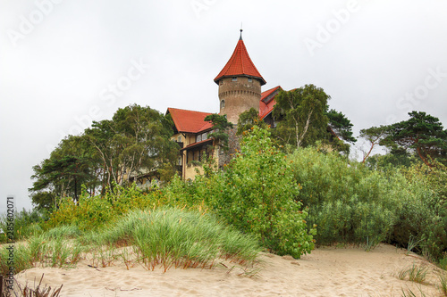 LEBA, POLAND - JULY 23, 2019: Neptun Castle on the Baltic Sea in Leba, Poland. In 1903 almost on the beach , the build of this interesting architectonically building was begun (completed in 1907).