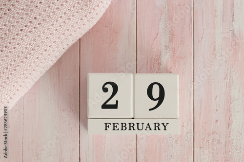 29 February Date on Cubes. Date on painted pink wood, next to baby blanket. Theme of baby due dates and birth dates.