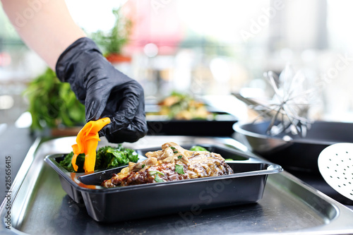 Catering. Meal prep.The cook prepares take-out dishes.