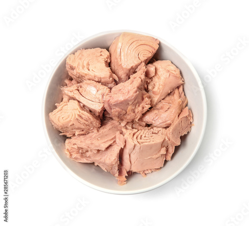 Bowl with canned tuna on white background, top view