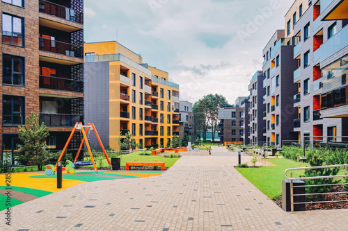 Children playground with European modern residential buildings quarter