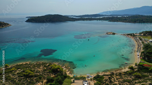Aerial drone photo of turquoise bay near famous Vourvourou and Diaporos island, Sithonia peninsula, Halkidiki, North Greece