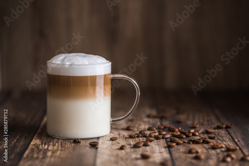 Cafe latte macchiato layered coffee in a see through glass cup