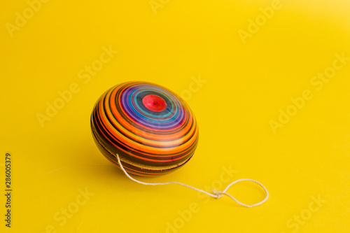 mexican toys, yoyo from Wooden in Mexico on yellow background