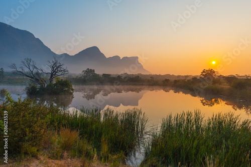 Magic sunrise landscape inside the Entabeni Safari Game Reserve with the Hanglip or Hanging Lip mountain peak, Waterberg, Limpopo Province, South Africa.
