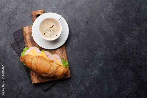 Coffee and croissant sandwich