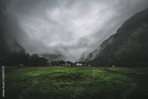 Lonely house standing in a misty mountains